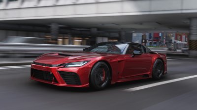Flat out through the expressway traffic in a red convertible during a night run across the city.