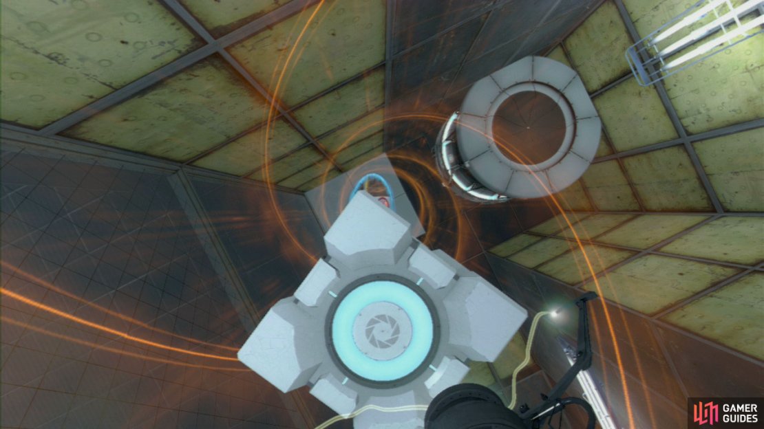 Player 1: Drop the Cube momentarily and look directly up at the ceiling, set your funnel up here and then ask your buddy to stand back on the button again. This’ll pull you up towards the ceiling and right out across the spike pit. Just before you go through the next portal in front of you, step out of the funnel to the ledge on your left. Player 1: Get your friend to come to the edge of the platform above and hold your Companion Cube up, as they aim down, you should jump up and release the Cube as player 2 grabs it from you.