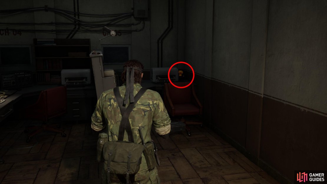Go down the western flight of stairs in the Graniny Gorki Lab 1F area to reach the Graniny Gorki Lab B1 (West) area. This GA-KO is in the corner of a room full of consoles past the rec room, behind a red chair.