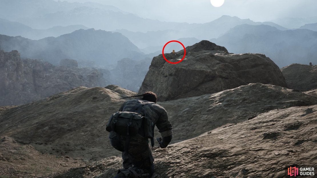 Head north over a broken, hilly stretch of barren land and keep your eyes to the left (west) to spot this GA-KO on a rock in the distance.