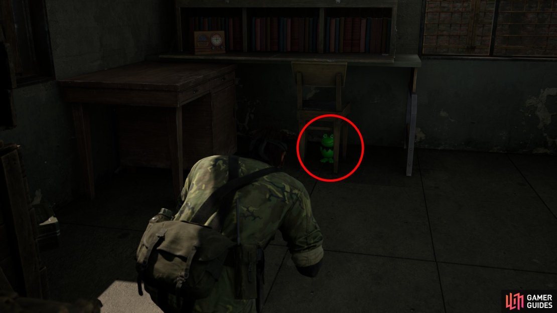 In the middle of the base is a two-room building. Find this Kerotan under a chair along the southern edge of the larger (eastern) building.