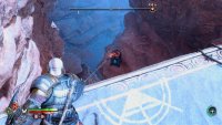 Head back up, climb up the ledges until you reach the top, and look over the ledge to the southeast.