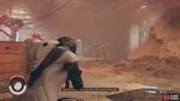 You will soon encounter robots, wipe them out then follow the wires to open the door.