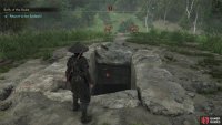 Find the exposed entrance to the tomb atop a hill,